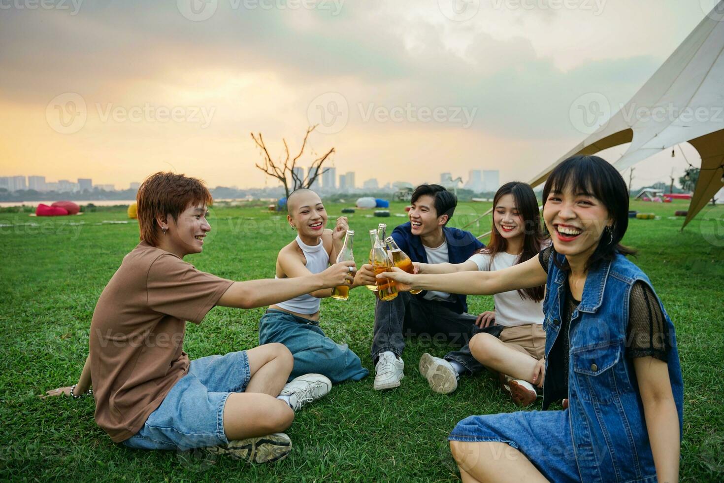 Image of group of friends celebrating and drinking beer together photo