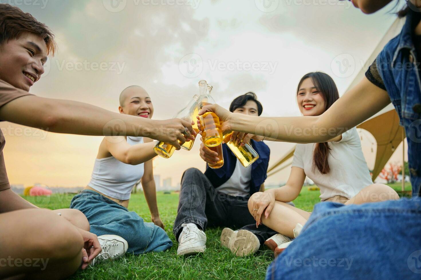 Image of group of friends celebrating and drinking beer together photo