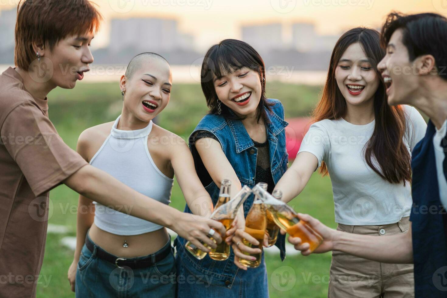 Image of group of friends celebrating and drinking beer together photo