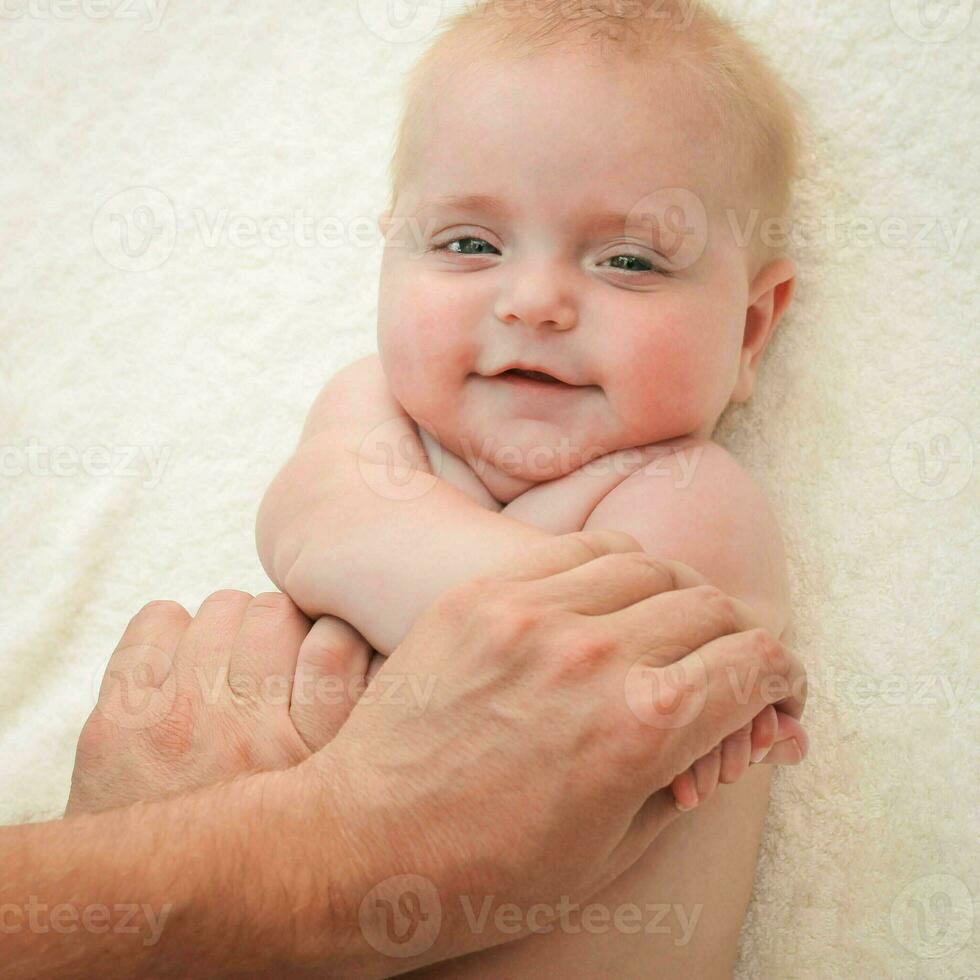 masseur doing exercise for hands little baby photo