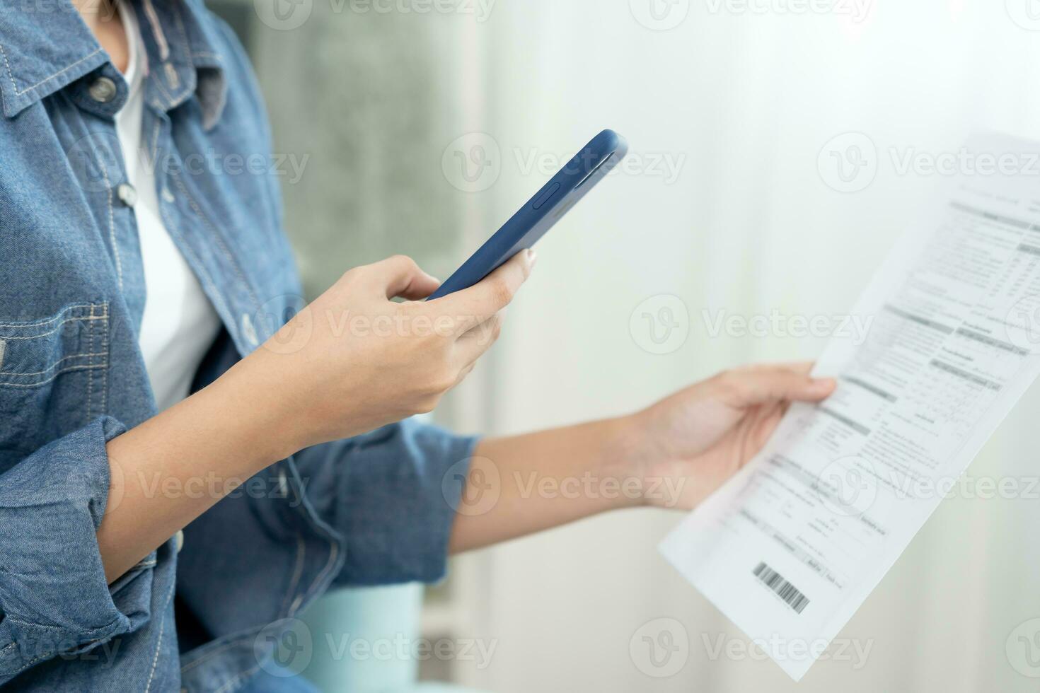 Modern woman use phone to scan barcode or QR codes to pay credit card bill after receive document invoice. payment, receive, paying electricity, digital payments without money, technology, scanning photo