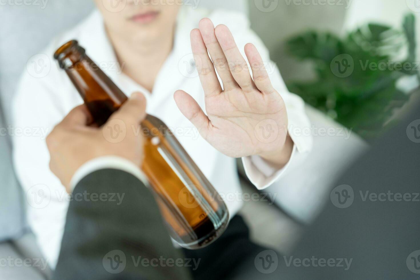 man refuses say no and avoid to drink an alcohol , hand show reject and stopping, alcoholism treatment, alcohol addiction, quit booze, Stop Drinking Alcohol. Refuse bottle liquor, unhealthy photo