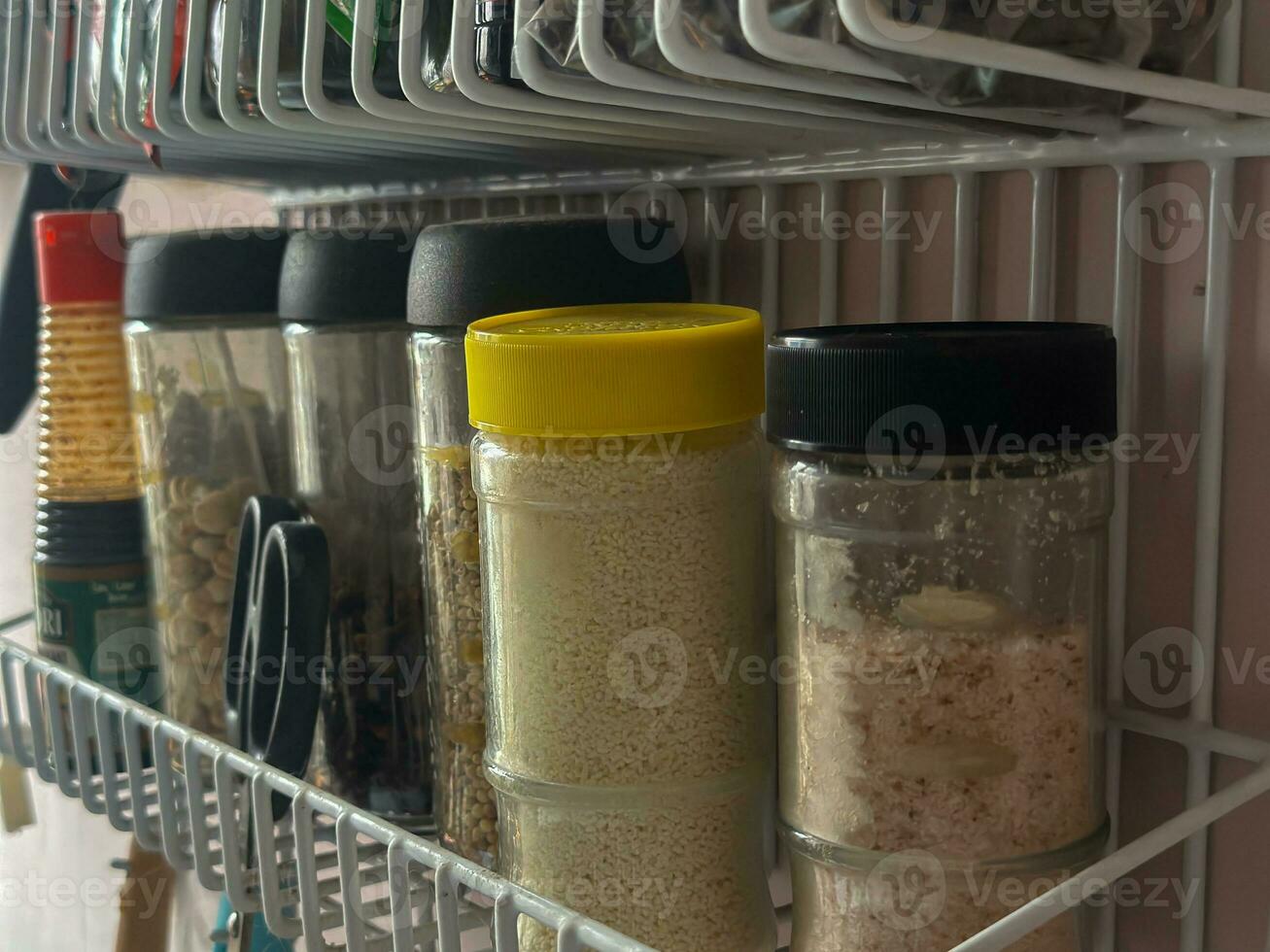 a jar with spices in white barred aluminum containers photo