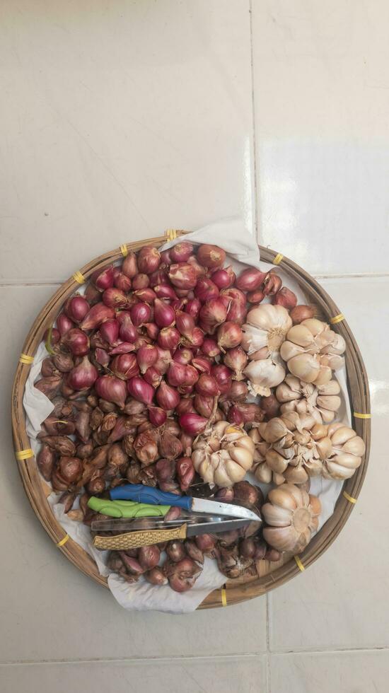 various types of onions in a basket seen from above photo
