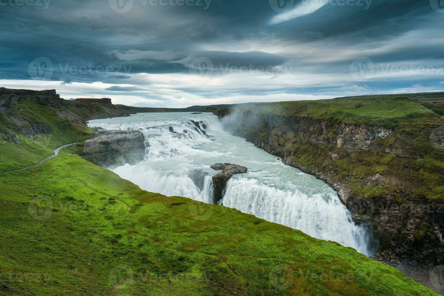 Gullfoss powerful waterfall flowing from Hvita river and moody sky in summer at Iceland photo