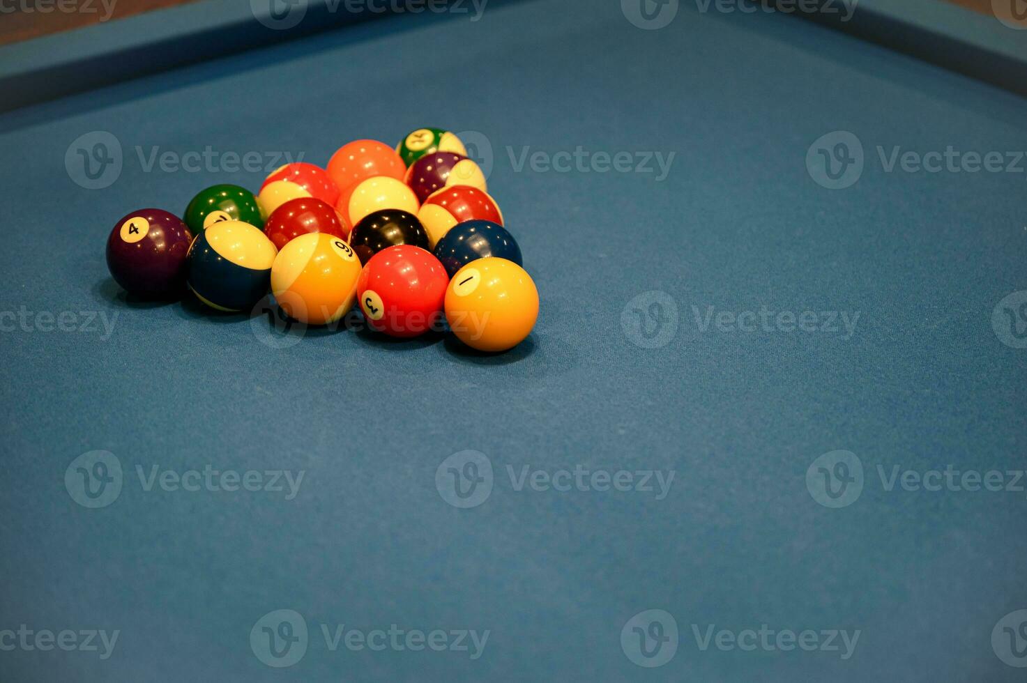 Set of billiard balls triangle on blue billiard pool table photo