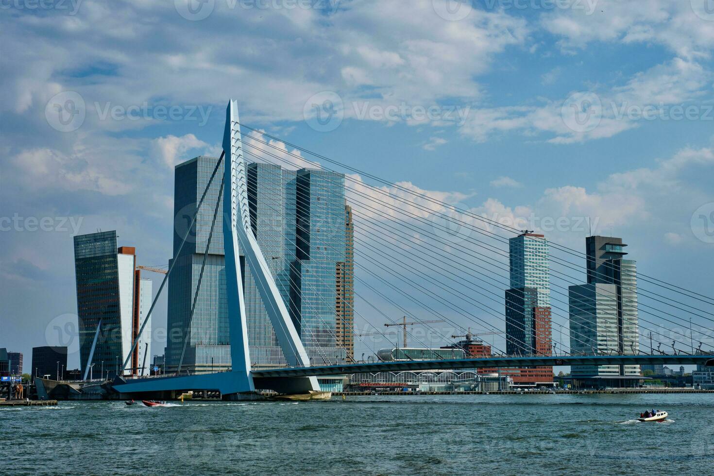 View of Rotterdam cityscape with Erasmusbrug bridge over Nieuwe Maas and modern architecture skyscrapers photo