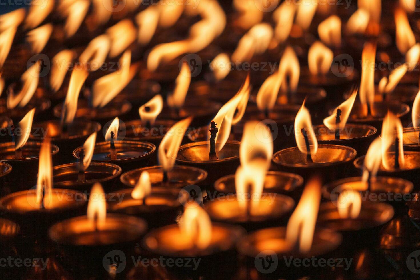 Burning candles in Buddhist temple photo