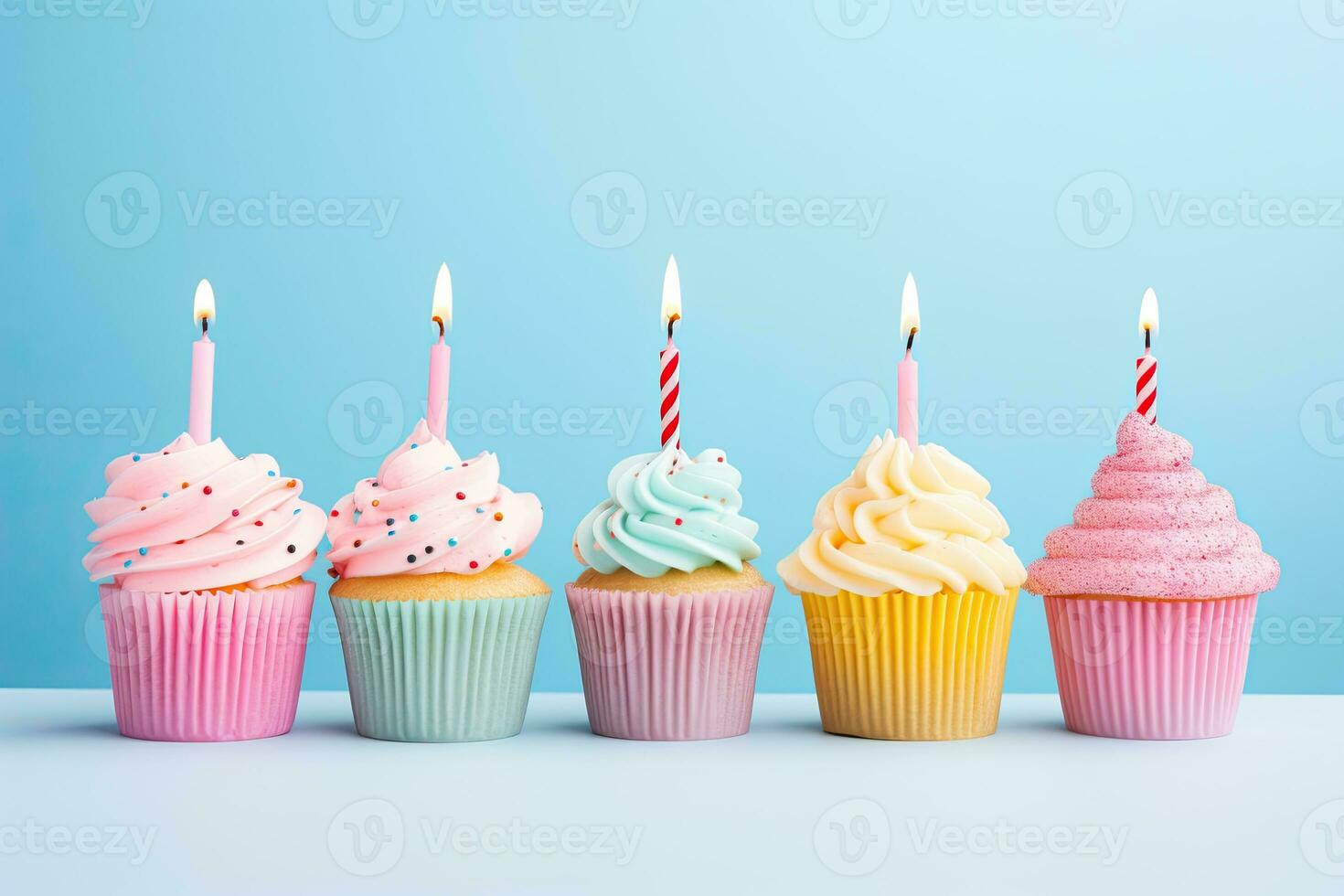 Generative AI, Row of colorful birthday cupcakes with candle of each, on light pink background photo