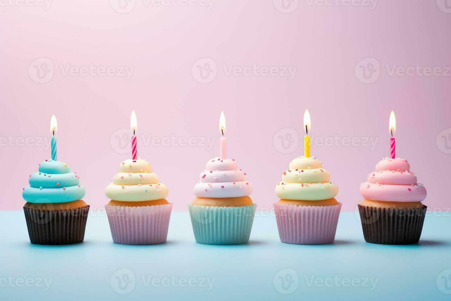 Generative AI, Row of colorful birthday cupcakes with candle of each, on light pink background photo