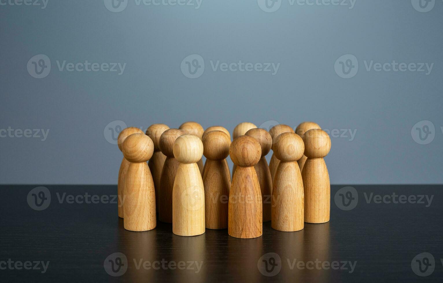 Stands alone group of people figurines. Society concept. Communication. Population and citizens. Large group. Community. Human resource, search for candidates. photo