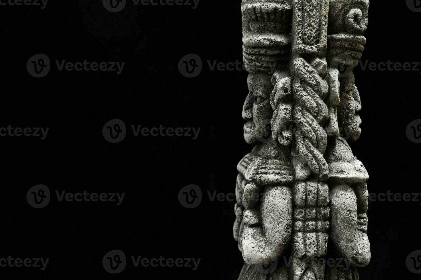 a carved statue of a man with a sword photo