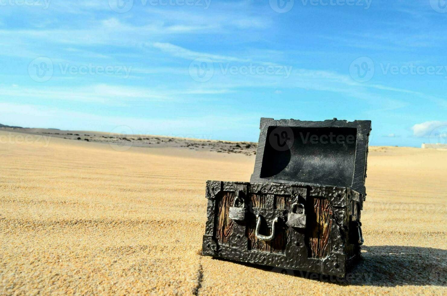 an old chest sitting on the sand in the middle of the desert photo