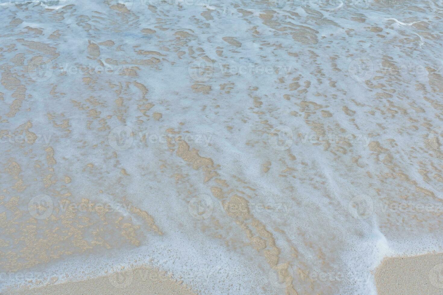 Soft wave of ocean on sandy beach. Summer vacation in island. clear azure water Background. photo