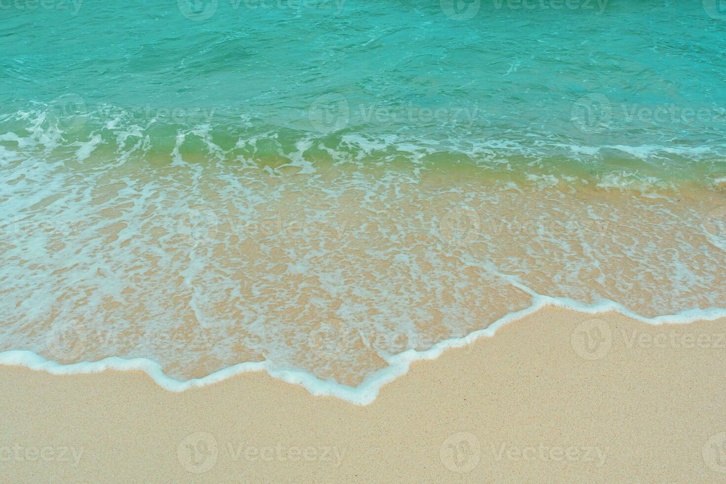 Soft wave of blue ocean on sandy beach. Summer vacation in island. clear azure water Background. photo