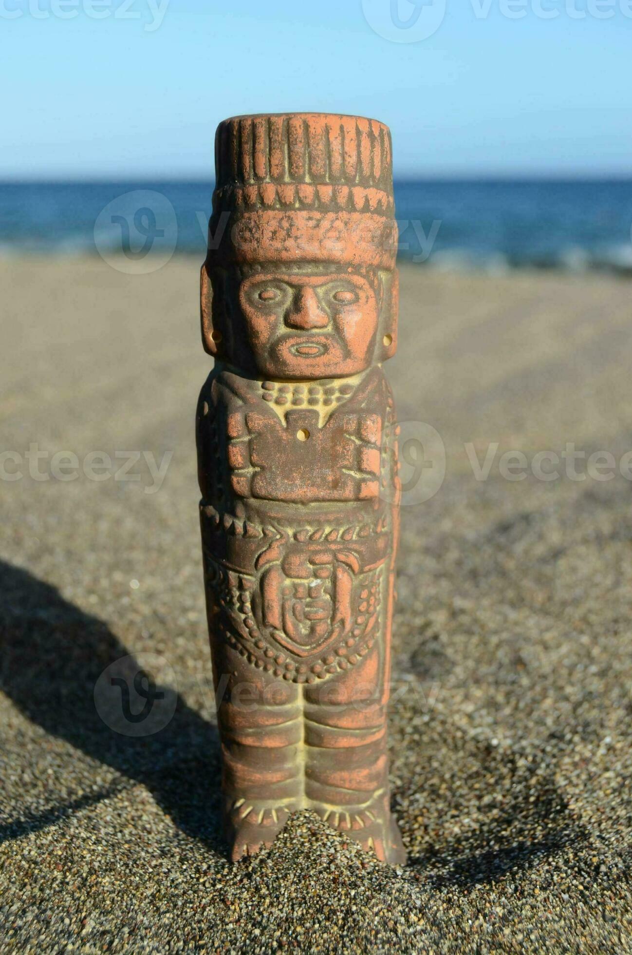 a small statue of a man on the beach 34554869 Stock Photo at Vecteezy