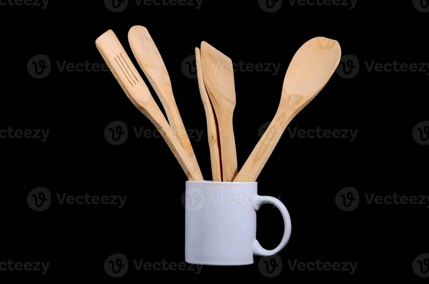 a mug with wooden utensils in it photo