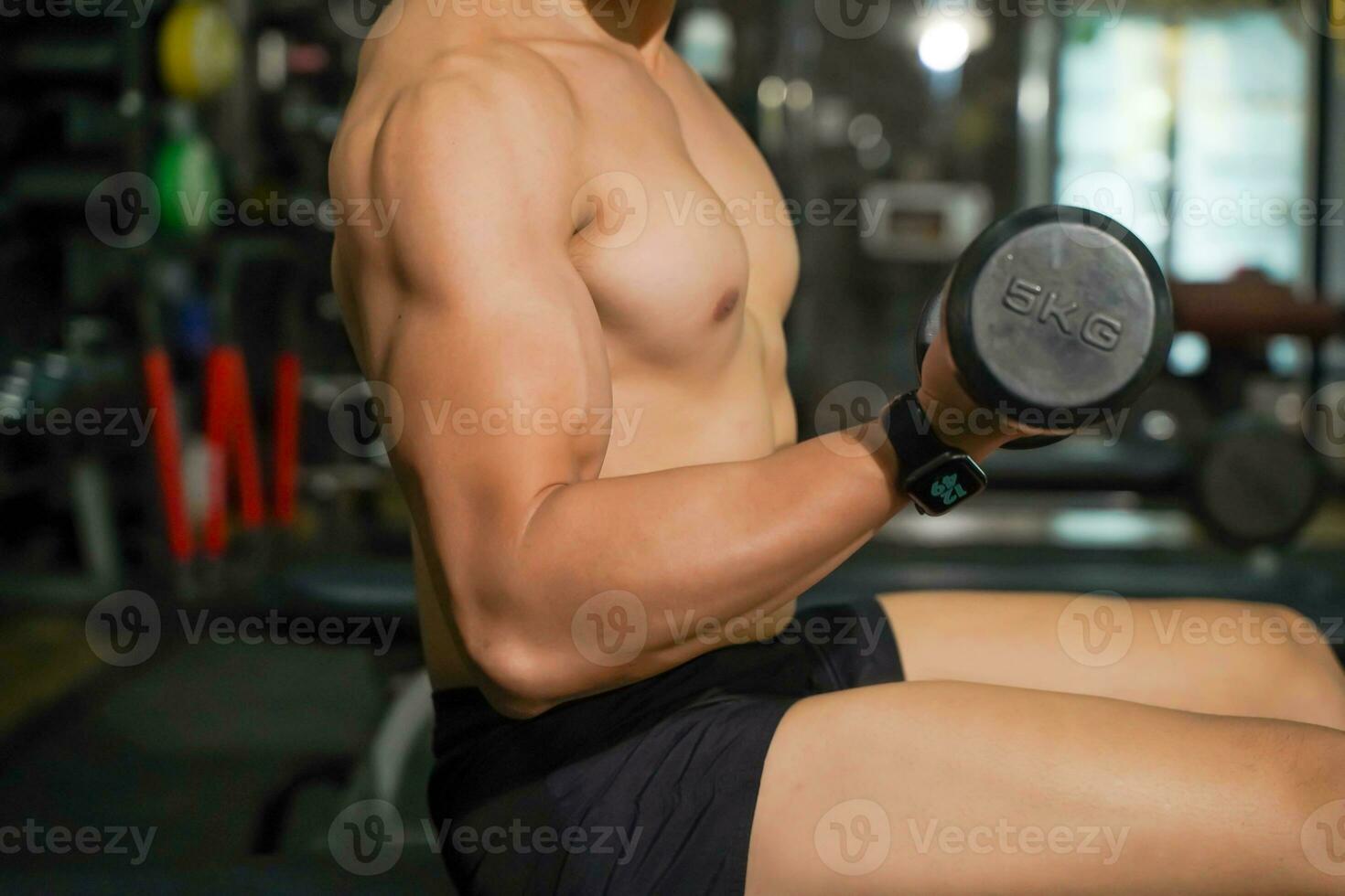 Closeup and crop perfect body of Asian guy playing weight training at fitness center. photo