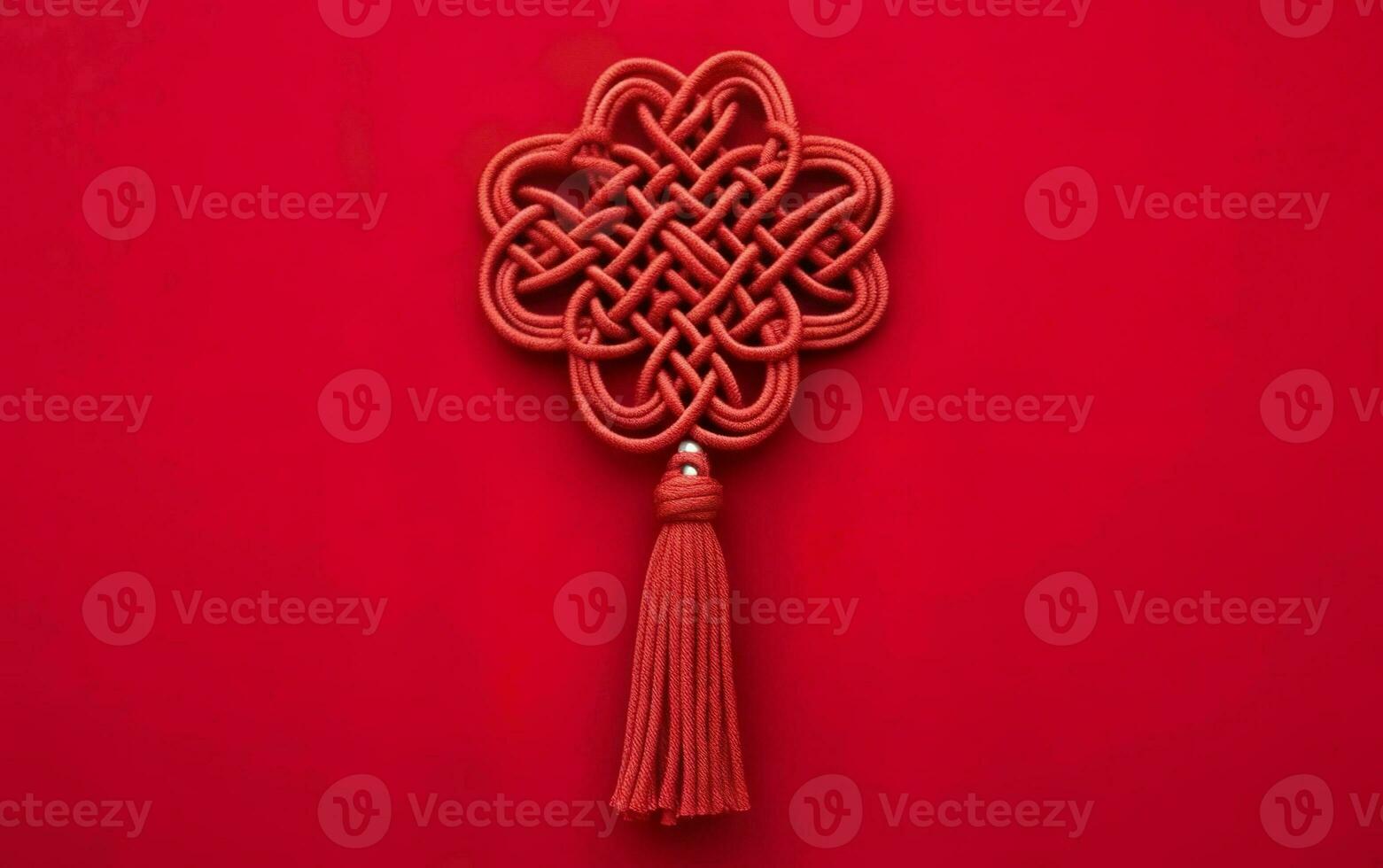 Asian symmetrical ornament, a red knot with brush fringe isolated on red background. Symbol of good luck. AI Generative photo