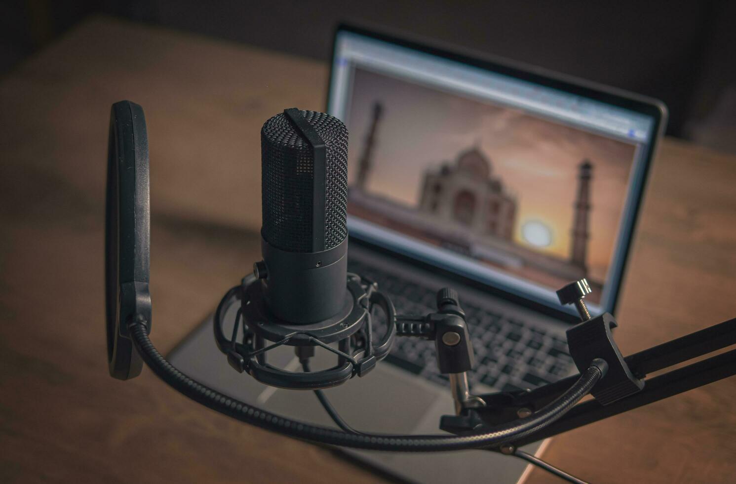 Home studio podcast interior. Large Microphone, notebook and notebooks on the table. Close-up photo
