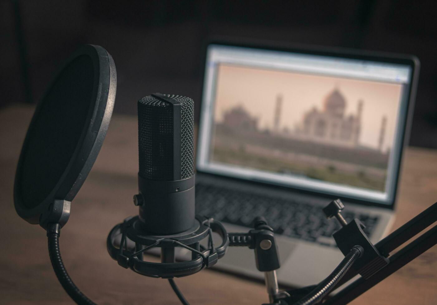 Home studio podcast interior. Large Microphone, notebook and notebooks on the table. Closeup photo