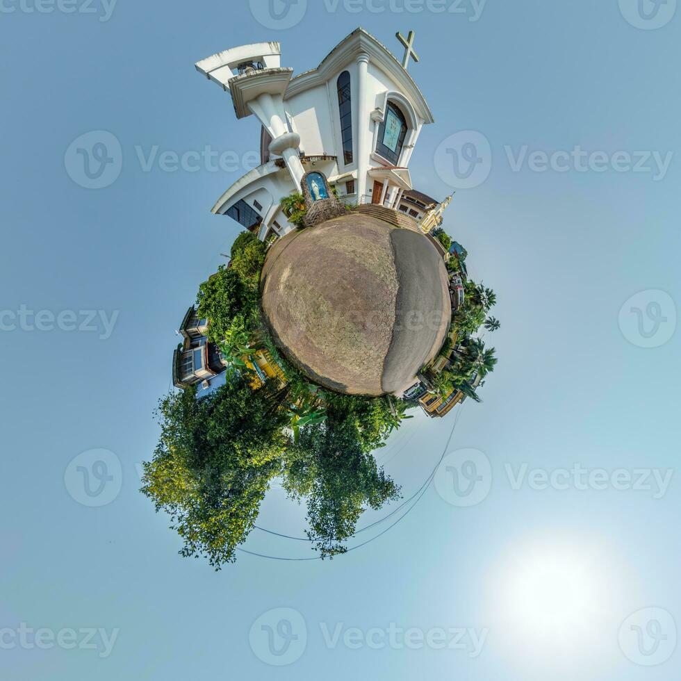 catholic church in jungle among palm trees in Indian tropic village on little planet in blue sky, transformation of spherical 360 panorama. Spherical abstract view with curvature of space. photo