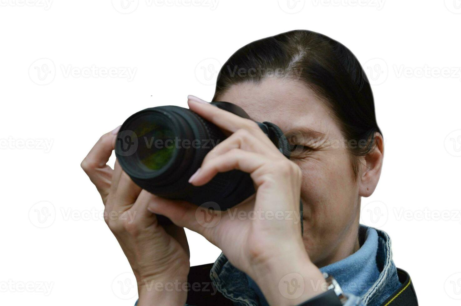 Portrait of a Caucasian woman covering her face with a camera, isolated on a white background. Professional photographer during shooting, the process of creating pictures. photo