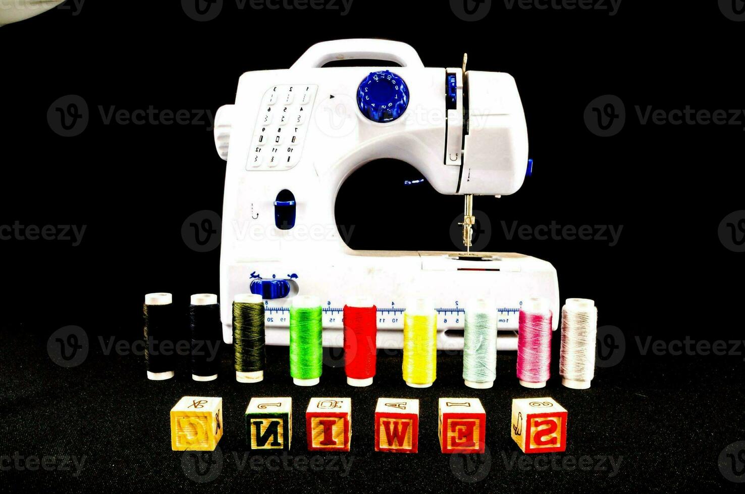 a sewing machine with a variety of different colored thread photo