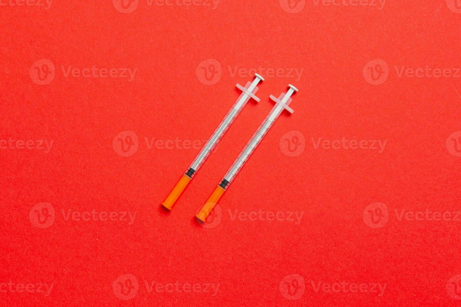 Top view of insulin syringes ready for injection on colorful background. Diabetic concept with copy space photo