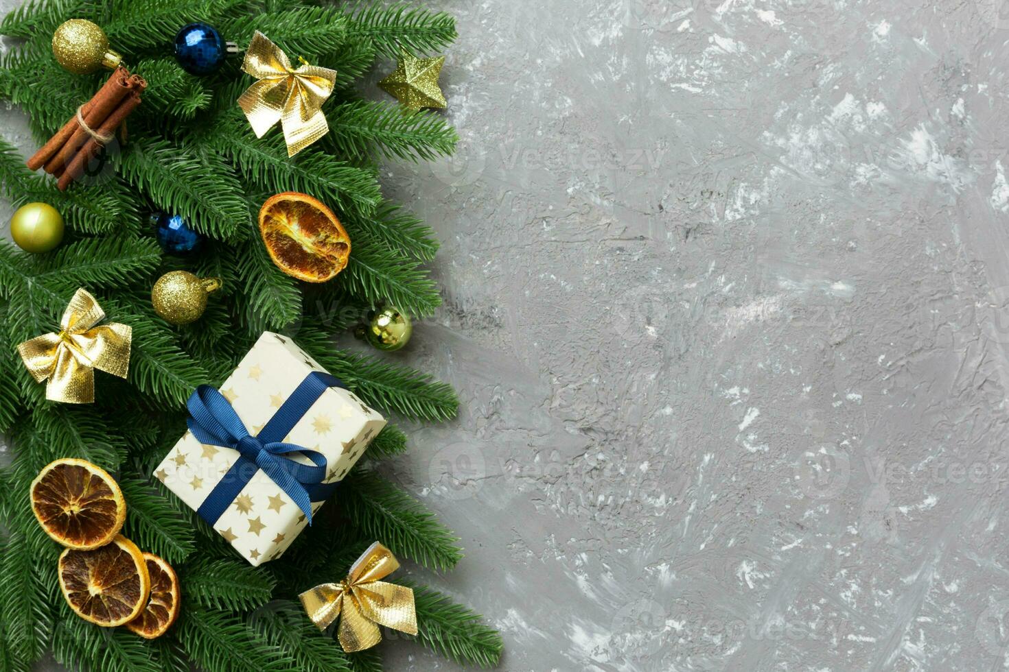 Christmas decorations and fir tree branch and gift boxon dark table. Top view frame with copy space photo