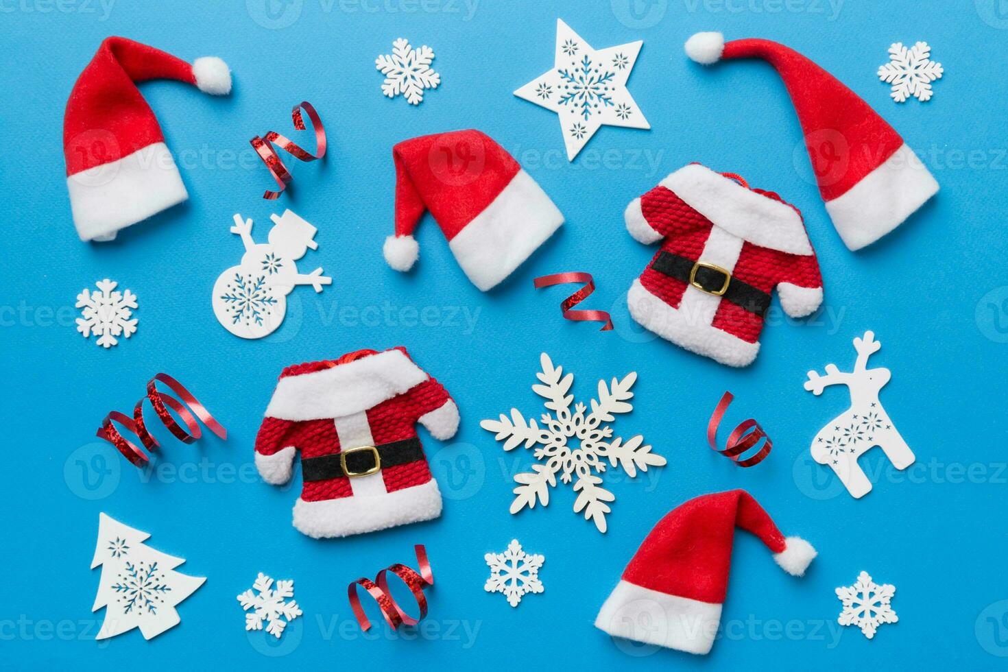Christmas composition. Christmas hat pants Santa fur coat on color background. Flat lay, top view, copy space. Xmas postcard template photo