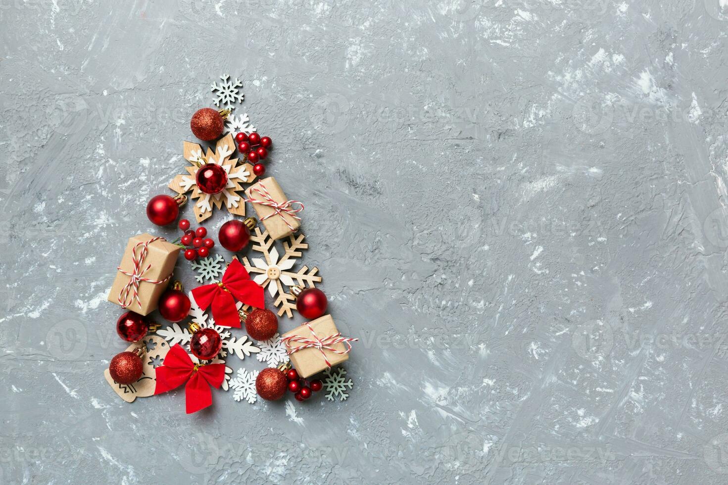 Christmas tree made from colored ball decoration on colored background, view from above. New Year minimal concept with copy space photo