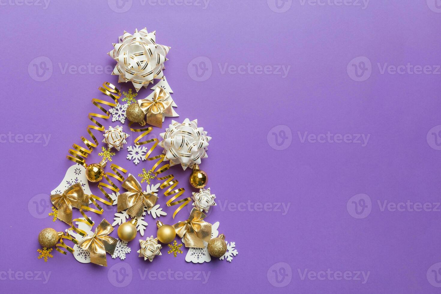Christmas tree made from colored ball decoration on colored background, view from above. New Year minimal concept with copy space photo