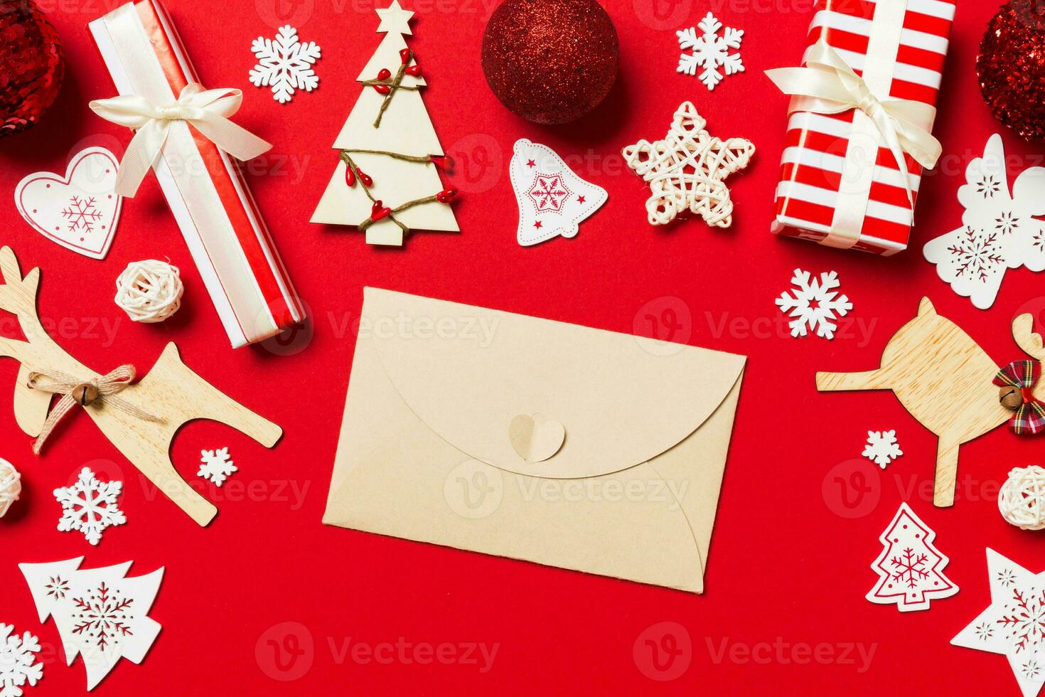 Top view of envelope on red background. New Year decorations. Christmas holiday concept photo