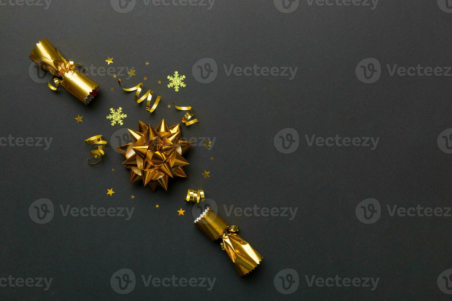 Christmas crackers with shiny confetti on color background, top view, copy space photo
