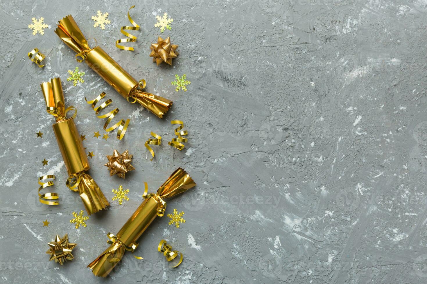 Christmas crackers with shiny confetti on color background, top view, copy space photo