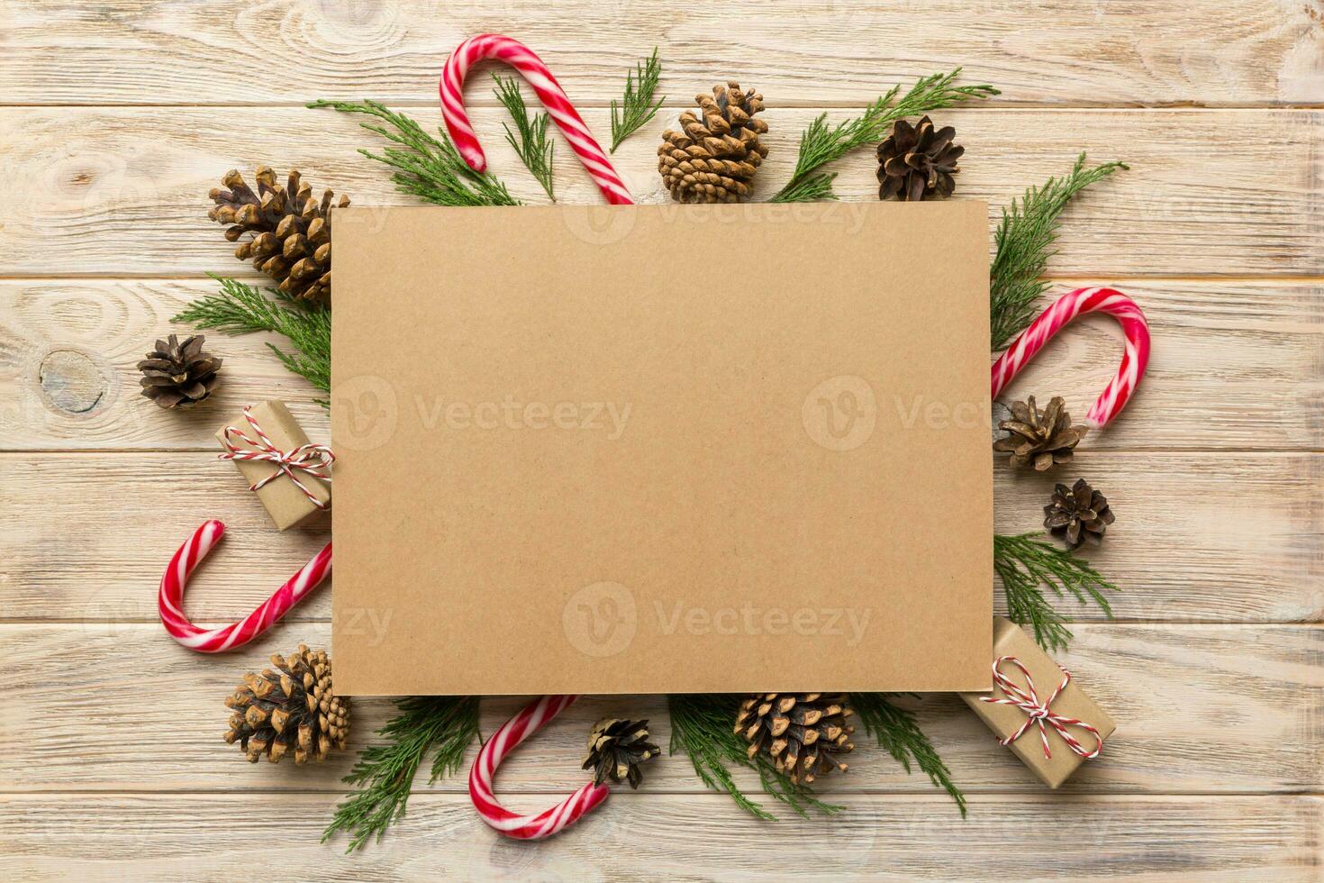 Flat lay Christmas composition. square Paper blank, pine tree branches, christmas decorations on Colored background. Top view, copy space for text photo