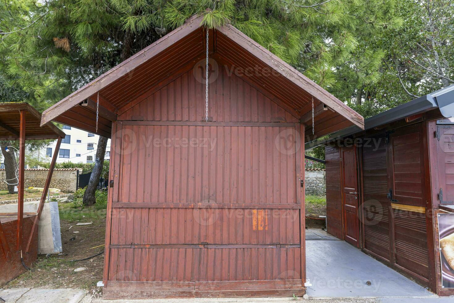 Front view of a brown wooden shack with closed shutters photo