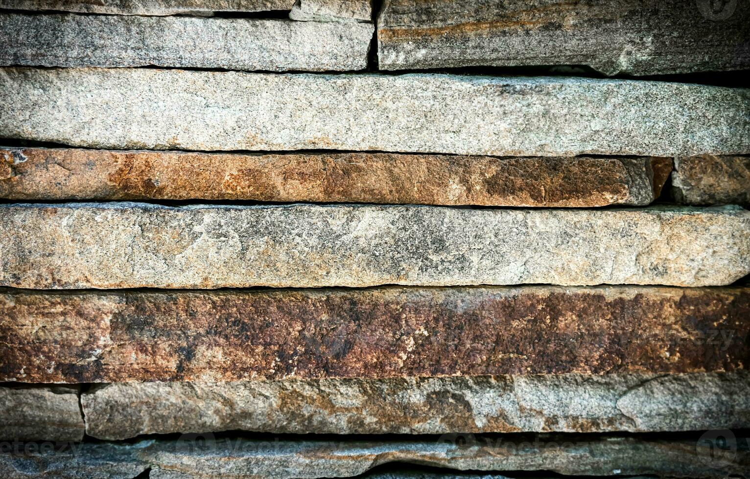Part of a stone fence. Selective focus. photo