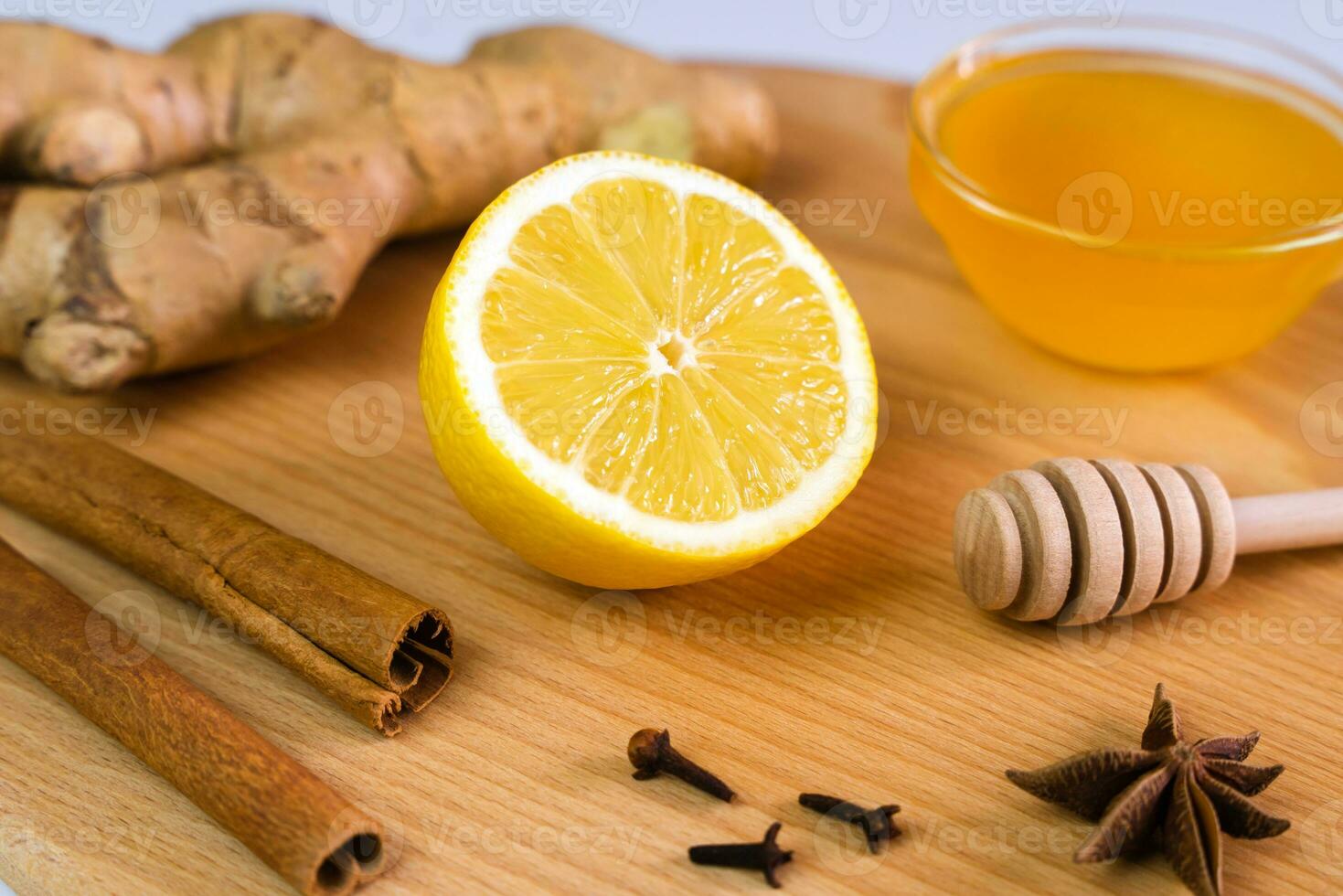 A lemon, honey, ginger and spices for a delicious vitamin and healthy drink. Alternative medicine. Close-up. Selective focus. photo