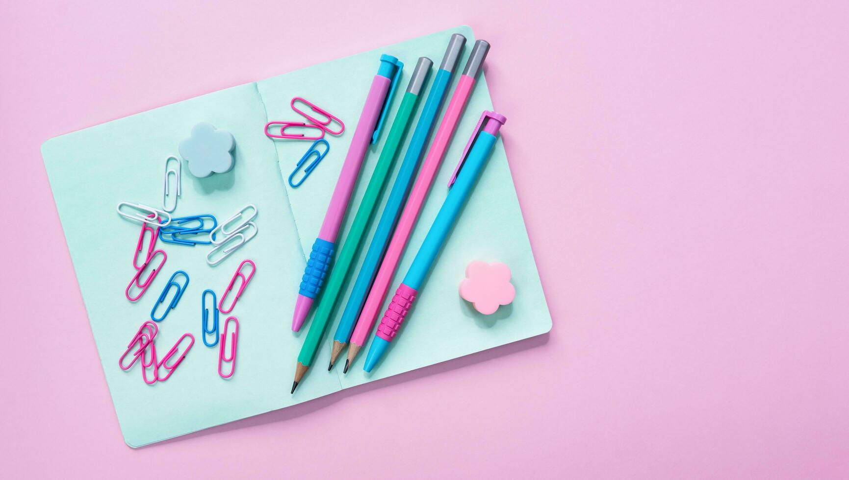 Colorful stationery on a pink background. Back to school. Flatlay. Top view. Copy space. photo