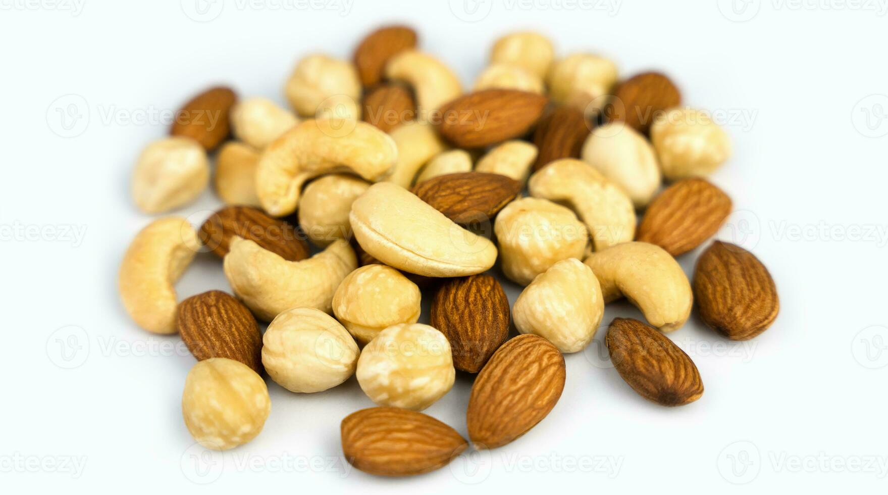 Mixed nuts almond, cashew, hazelnut isolated on white background. Close-up. Banner. Selective focus. photo