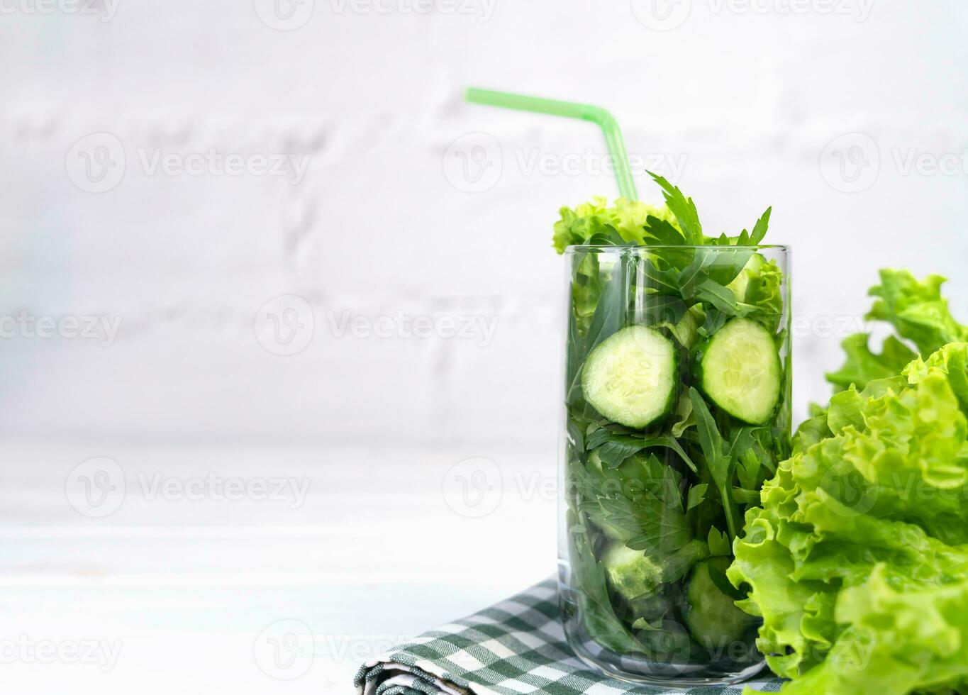 Ingredients for healthy vegetable smoothie in a glass on the table. Healthy food. Detox. Copy space. Selective focus. photo