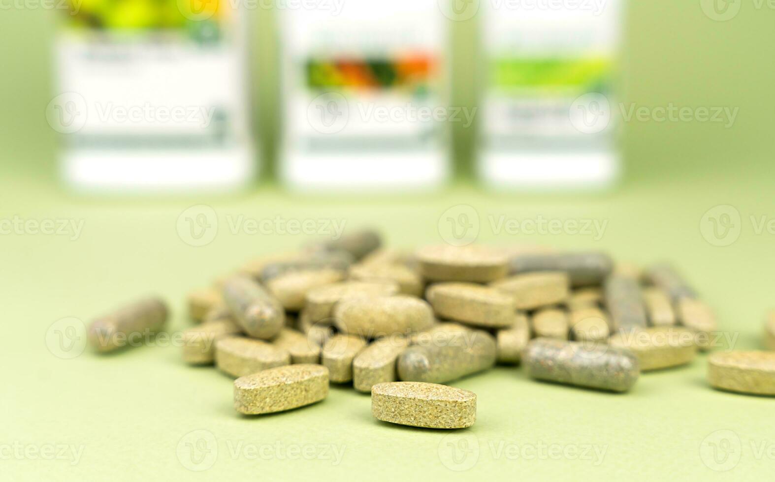 Natural vitamins and supplements on a green background. Close-up. Selective focus. photo