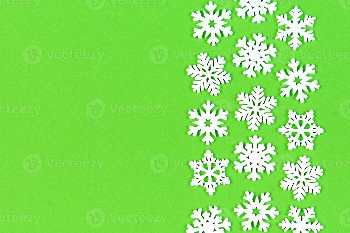 Top view of white snowflakes on colorful background. Winter weather concept with copy space. Merry Christmas concept photo