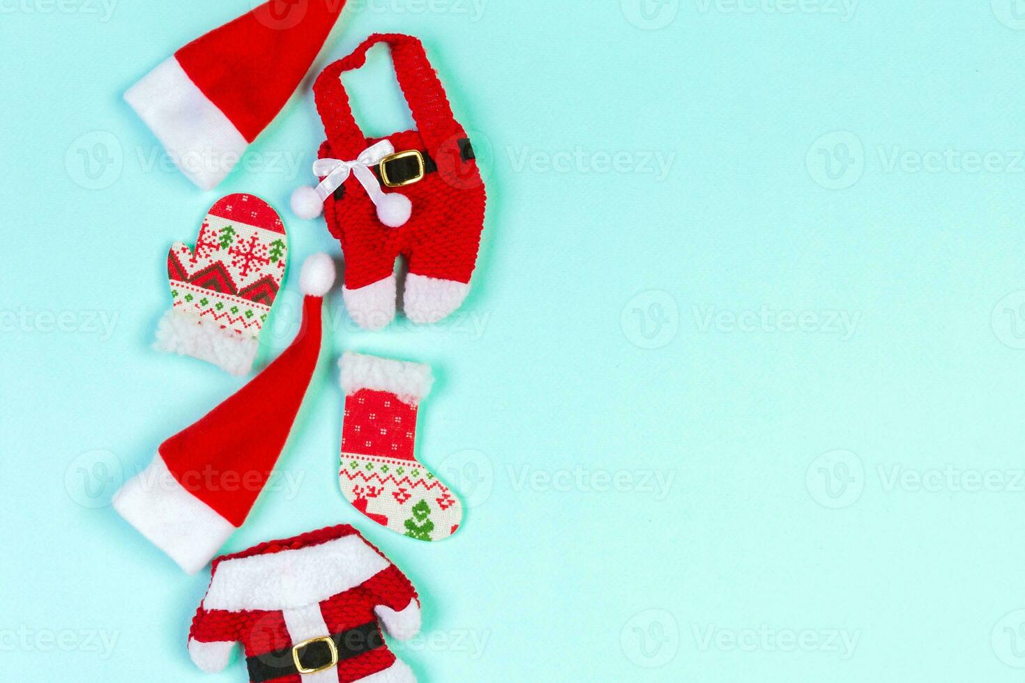 Top view od stylish red Santa hats on colorful background. Merry Christmas concept with copy space photo