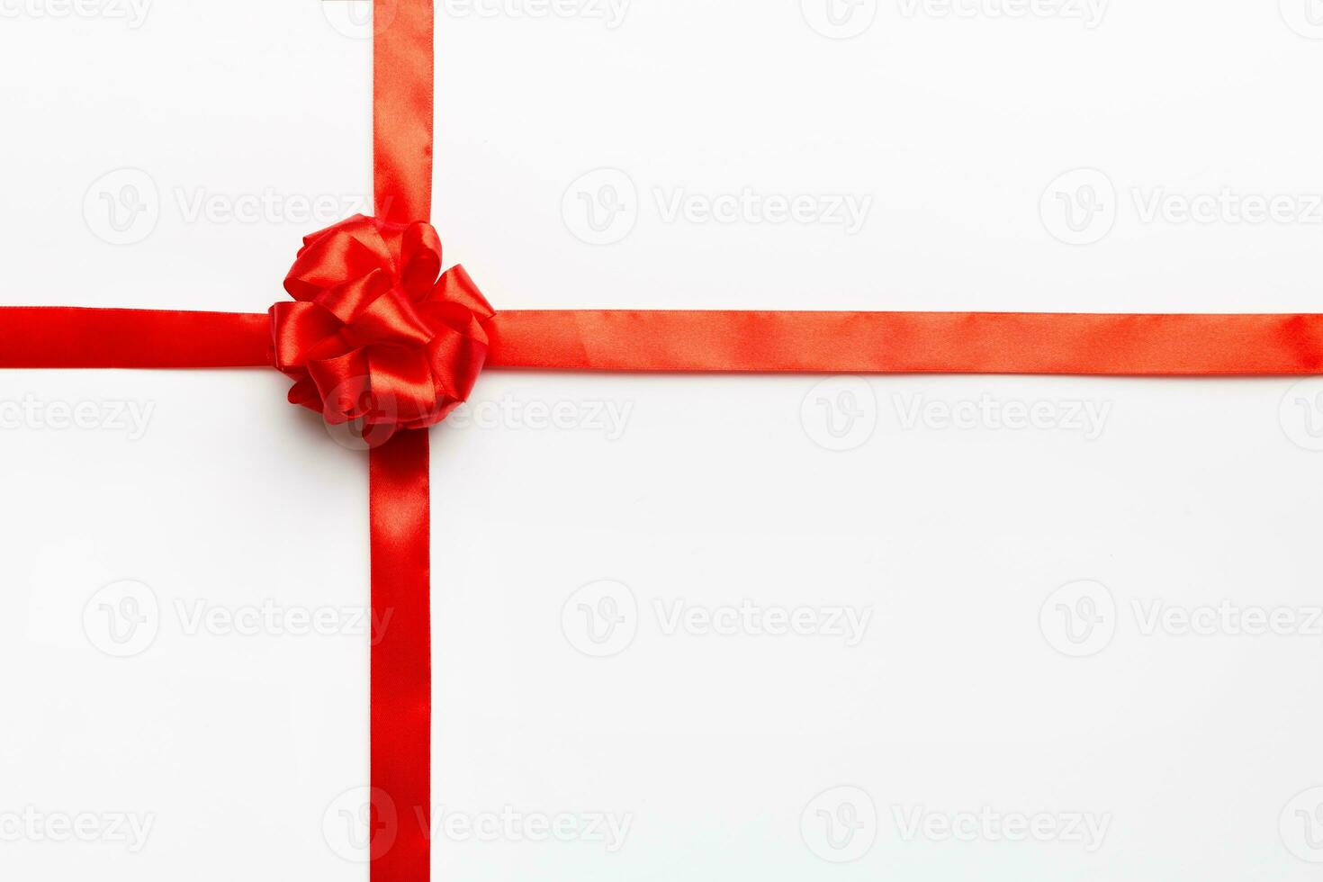 Top view of Red ribbon rolled and red bow isolated on colored background. Flat lay with copy space photo