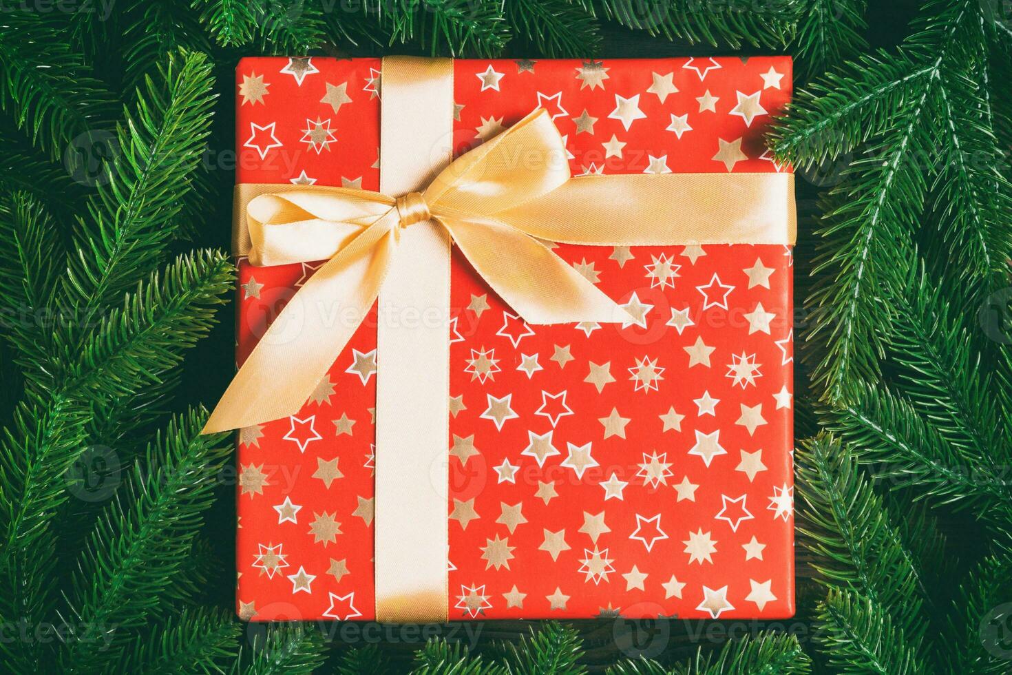 Top view of holiday gift box and fir tree branches with empty space for your design. New year ornament concept photo