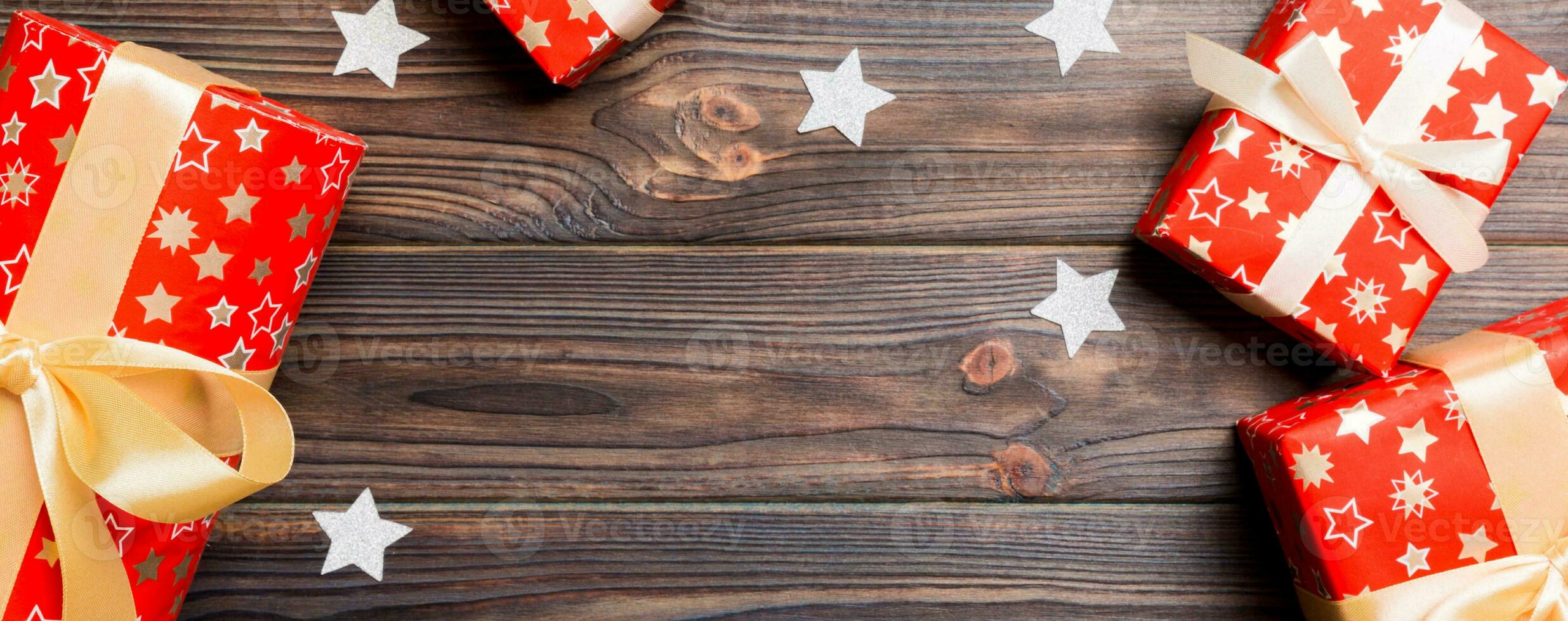 Top view Banner of Christmas background made of gift boxes and snowflakes on wooden background. New year holiday concept with copy space photo
