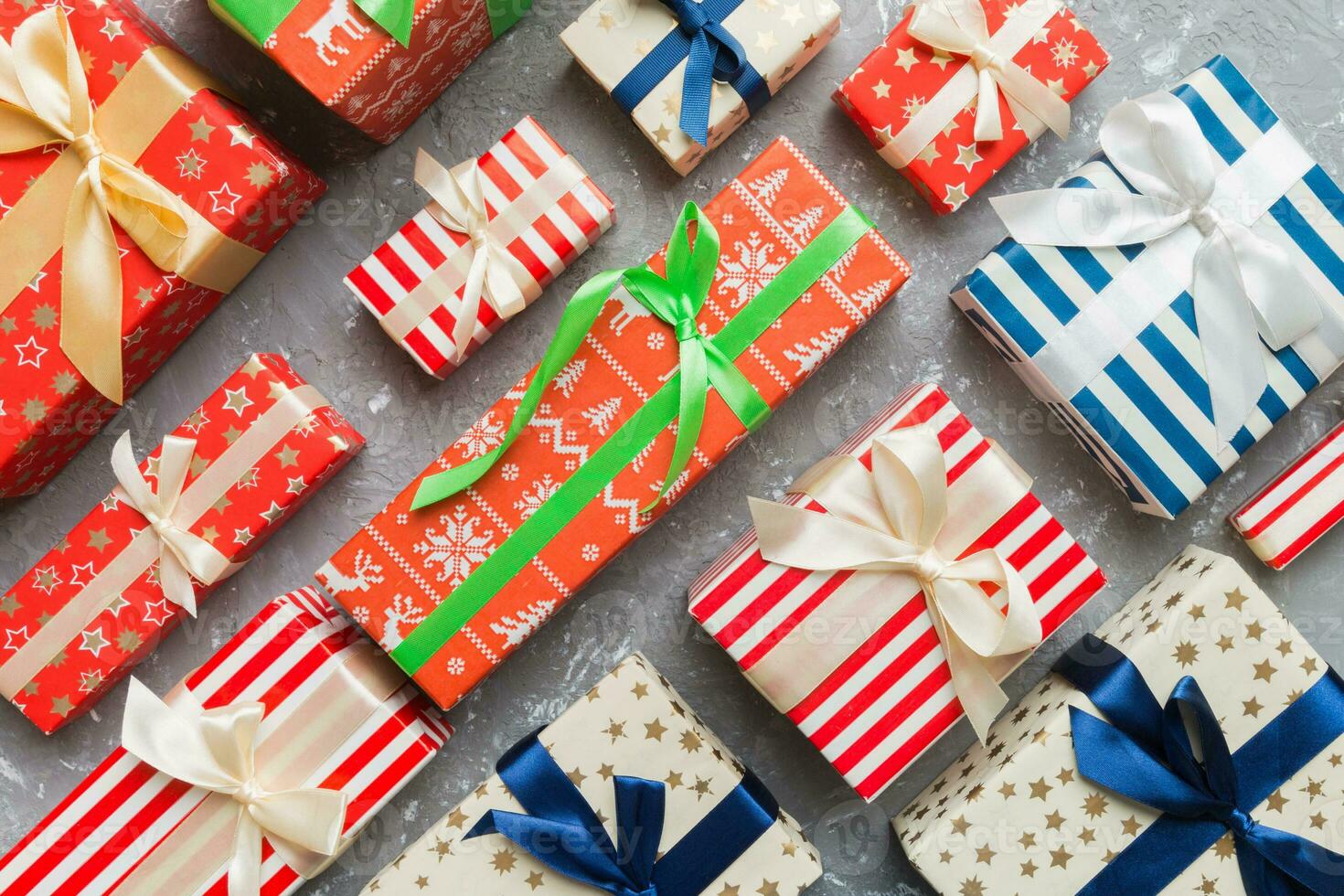 A lot of Christmas gift boxes in colored paper decorated on table, Top view close up. Many present New Year gift photo